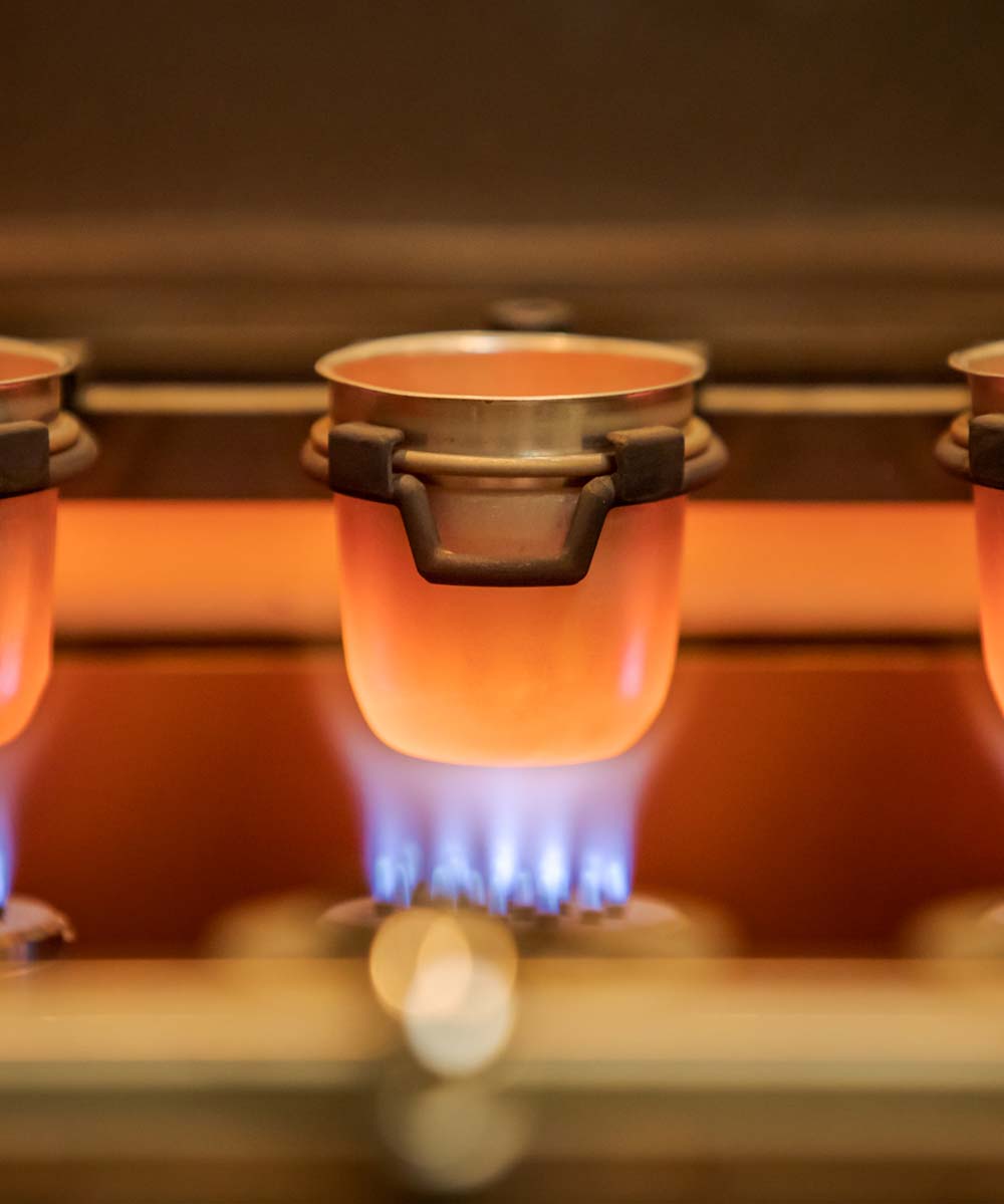 Red hot cups of material are heated over direct blue flame