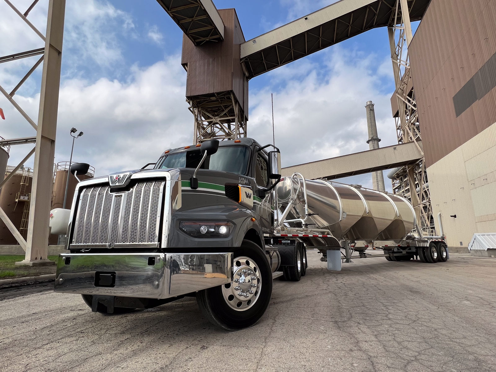A semi-tractor truck sits at a loading facility
